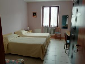 Postel nebo postele na pokoji v ubytování Albergo Breglia