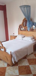 a bedroom with a large bed with a blue net at Adam and Eve House in Luxor