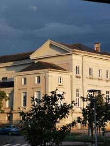 a large white building with a car in front of it at La Canopée in Cholet