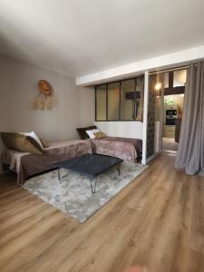 a living room with a couch and a table at La Canopée in Cholet