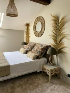 a bedroom with a bed with a mirror on the wall at La Canopée in Cholet