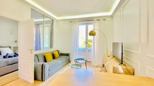 a living room with a couch and a bed at Designer Garden View AC, Fiber Wifi Heart of Monaco in Monte Carlo