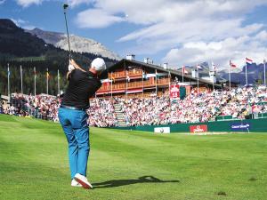 a man swinging a golf club on a golf course at Résidence Plambramois in Crans-Montana