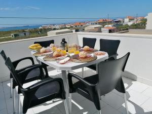 a table with food and drinks on a balcony at Baleal Atlantic View House in Baleal