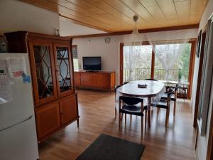 a kitchen and dining room with a table and a refrigerator at Appartment Gude, Ulm- Stuttgart in Heroldstatt