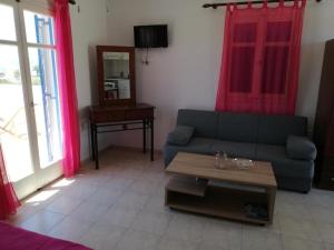 a living room with a couch and a table at Papikinou Studios in Adamantas