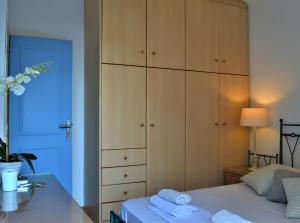 a bedroom with a large cabinet next to a bed at Seas the day in Mýkonos City