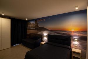 a bedroom with a wall mural of a beach at Hotel La Sorgente HS in Paestum +56 photos