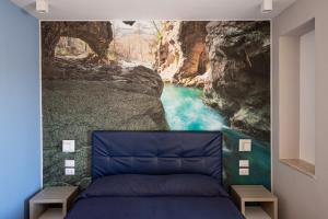 a bedroom with a wall mural of a river at Hotel La Sorgente HS in Paestum