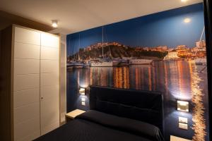 a bedroom with a wall mural of a harbor at Hotel La Sorgente HS in Paestum