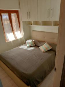 a bed with two pillows on it in a bedroom at CasaTurchese-Colline Costa Smeralda in Olbia
