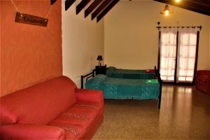 a living room with a couch and a bed at Kalimera (Buenos Días) in Yala