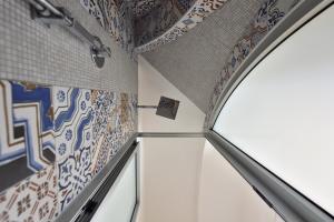 a room with mosaics on the walls and a window at Sirena Apartment in Minori +36 photos