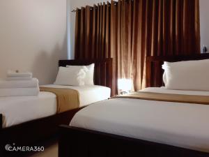 מיטה או מיטות בחדר ב-Marjaan Apartments
