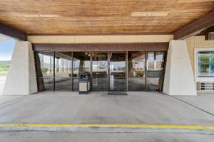 a building with glass doors and a wooden ceiling at OYO Hotel Junction TX I-10 in Junction