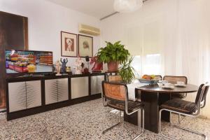 a living room with a table and chairs and a tv at CASA D'ARTISTA in Cavallino-Treporti +13 photos