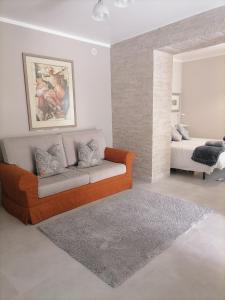 a living room with a couch and a bed at SoleLuna in Santa Elisabetta