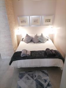 a bedroom with a large white bed with three pillows at SoleLuna in Santa Elisabetta