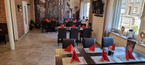 a restaurant with tables and chairs with red napkins on them at Hakans Moselblick Ferienwohnung in Treis-Karden