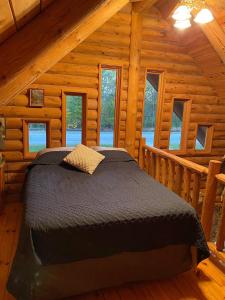 a bedroom with a bed in a log cabin at Carries Cabin in Harpers Ferry