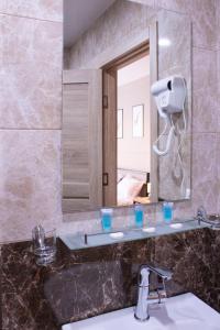 a bathroom with a sink and a mirror at ALOFT in Kazbegi
