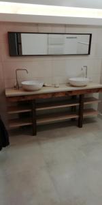 a bathroom with two sinks and a mirror at colmar in Horbourg