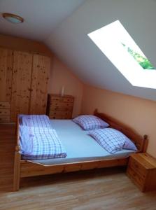 a bedroom with a bed and a skylight at Sklípek v Agátí in Drnholec