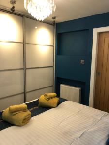 a bedroom with a bed with two towels on it at Roserin Coorie, Perth - just a few minutes walk from the city centre! in Perth