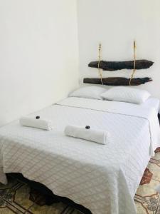 two beds with white sheets and towels on them at Casa Mama Fanti in Esquipulas