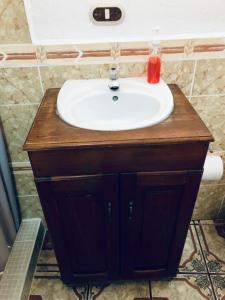 a bathroom sink with a red soap on top of it at Casa Mama Fanti in Esquipulas