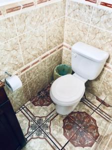 a bathroom with a white toilet in a room at Casa Mama Fanti in Esquipulas