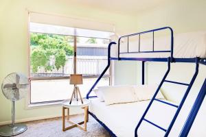 a bedroom with two bunk beds and a window at The Clydesdale - Spacious 4 bedroom Home in Echuca
