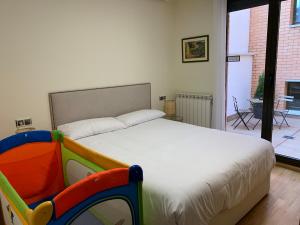 a bedroom with a large bed with a toy crib at Vivienda turística Las Cigüeñas con parking in Soria