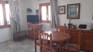 a dining room with a table and a television at Urbanizacion Vera Costa, Vera in Vera