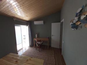 a room with a table and a chair and a door at Tree House in Setúbal