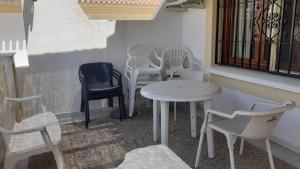 a group of white chairs and tables on a balcony at Urbanizacion Vera Costa, Vera in Vera +3 photos