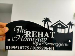 a sign for the rental homesteadasyysicalysicalysical at TheREHAT Homestay Kijal Terengganu in Kijal