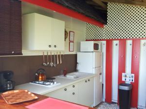 a kitchen with a stove, sink and refrigerator at Poerani Moorea in Moorea