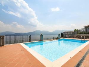 a swimming pool with a view of the water at Belvilla by OYO Vigneto Di Diciotto in Oggebbio