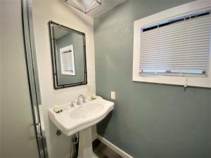 a bathroom with a sink and a mirror at Pinewoods Resort and RV Park in Duck Creek Village