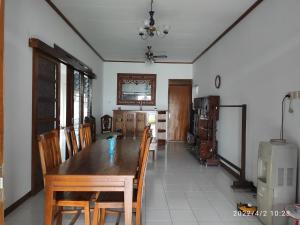 スマランにあるKelana 2 Nice Homestay (5 Bed Rooms) Semarangのダイニングルーム(木製テーブル、椅子付)