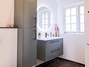a bathroom with a sink and a refrigerator at Modern Retreat in Marielyst - By Traum Ferienwohnungen in Marielyst +40 photos