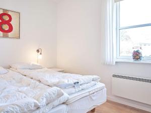 a bedroom with two white beds and a window at 4 person holiday home in Allinge-By Traum in Allinge