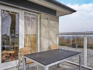 a patio with a table and chairs on a patio at Holiday home Allinge XXIII in Allinge