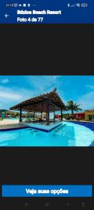 uma imagem de uma piscina com um pavilhão de madeira em Búzios Beach Resort Residencial 1305 em Búzios