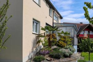 a house with a garden in front of it at Ferienwohnung Melcher in Hard