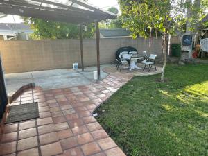 a patio with a table and a grill in a yard at The Village in North Hollywood