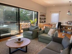 a living room with couches and a table at The Point in Boomerang Beach