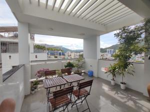 a balcony with a table and chairs on a building at NGỌC QUÝ Mini House in Quy Nhon