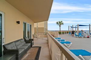 a balcony with a couch and a playground at Sunrise Beach Resort V in Panama City Beach